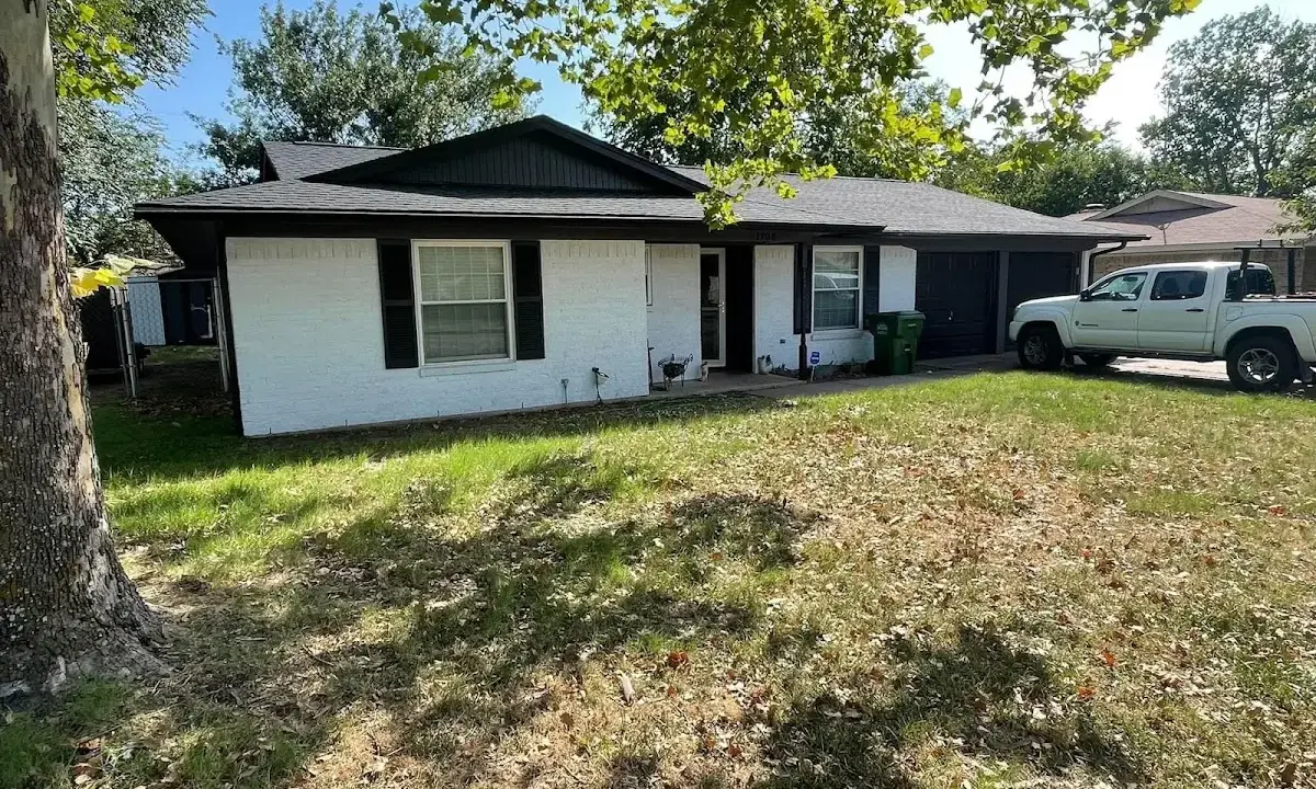 Professional roofing crew working on a residential roof in Waxhaw